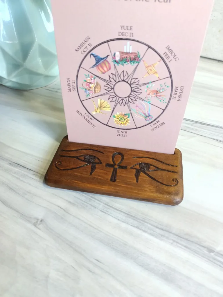 Wooden stand with wiccan wheel of year card in Egyptian style