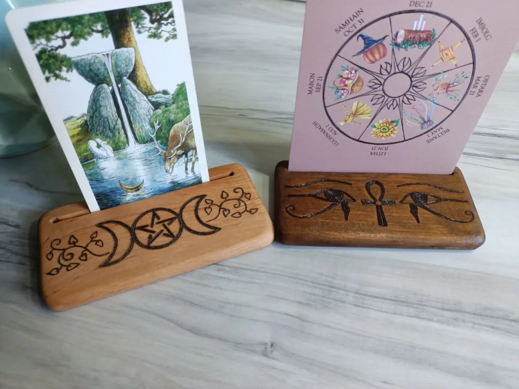 Triple goddess and Egyptian ankh themed card stands holding Tarot and Wheel of year cards